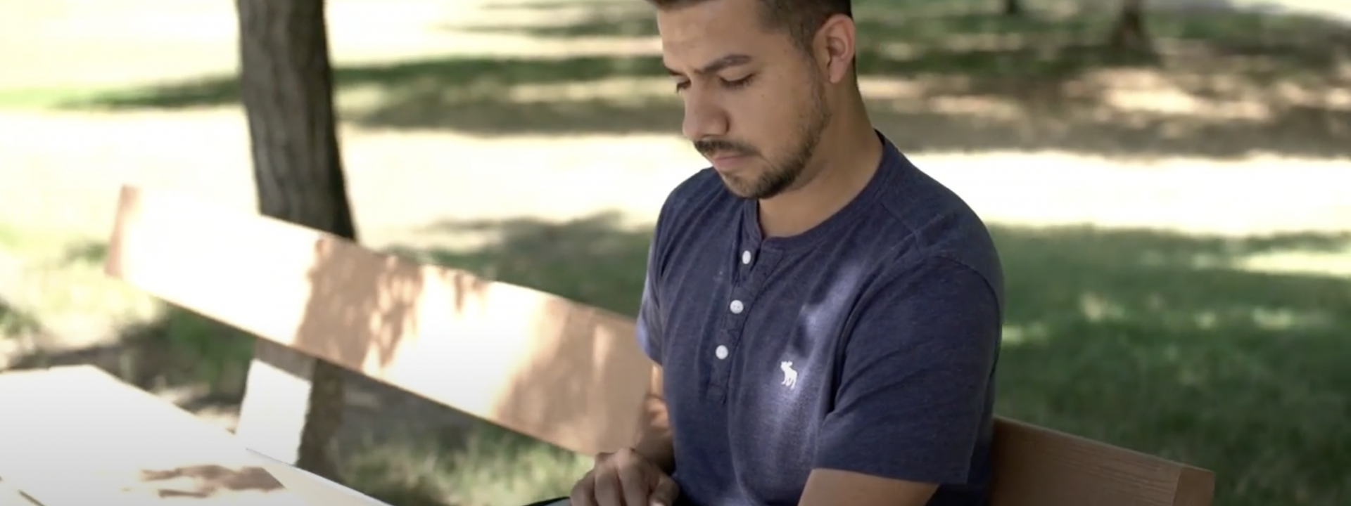 Student on bench with laptop