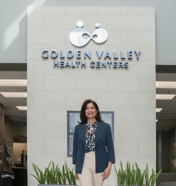 Woman standing in front of hospital sign