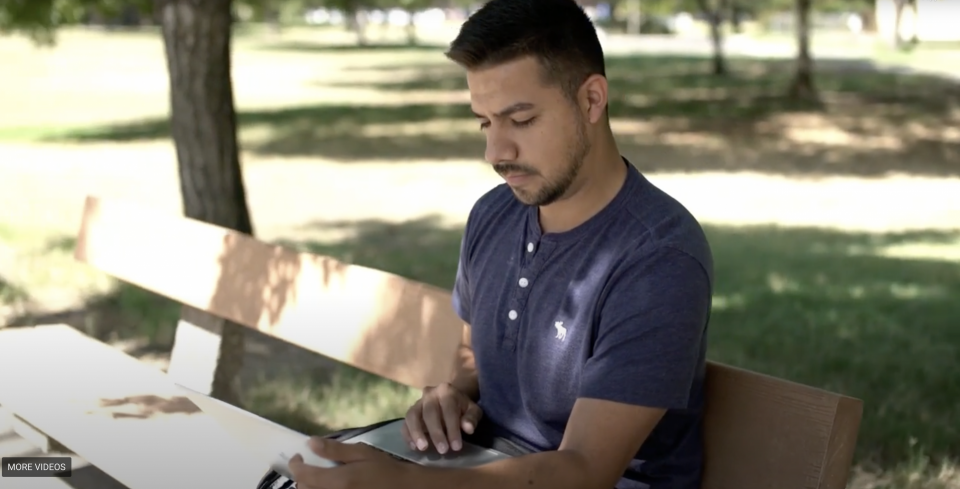 Student on bench with laptop