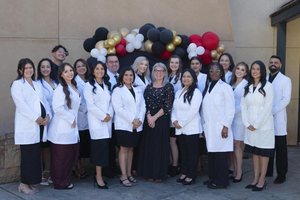 Nursing graduates wearing white coats