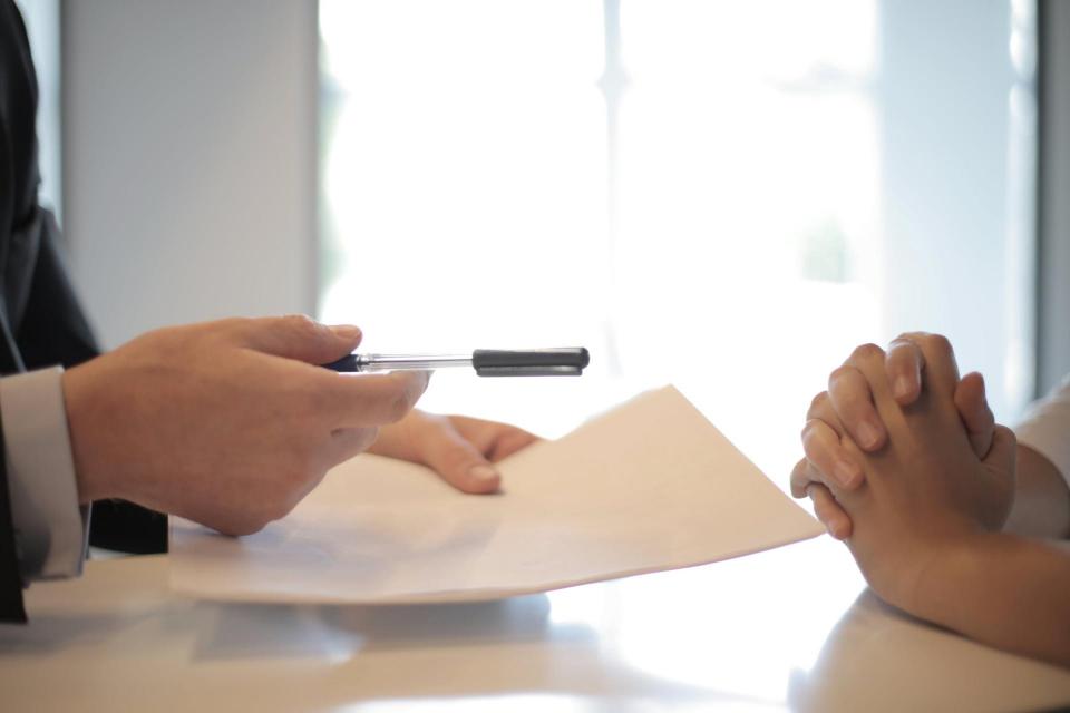 People signing paperwork